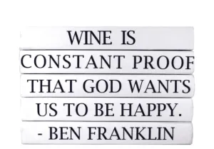 "WINE IS CONSTANT PROOF THAT GOD WANTS US TO BE HAPPY." Quote Book Stack